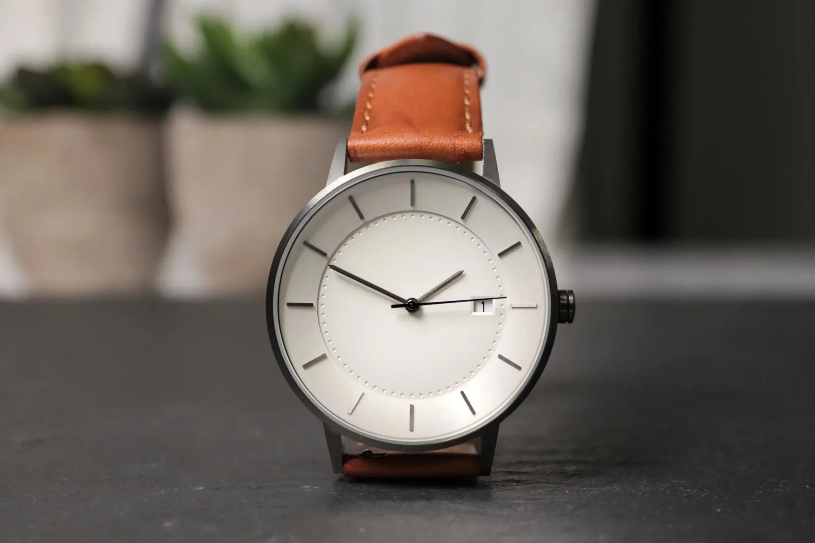 Analog wristwatch on wooden surface